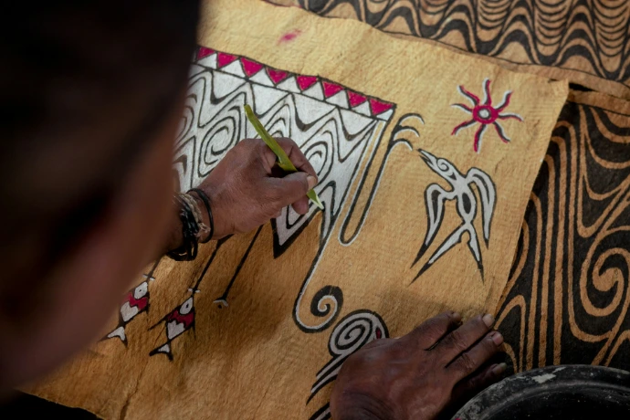 a person drawing on a sheet